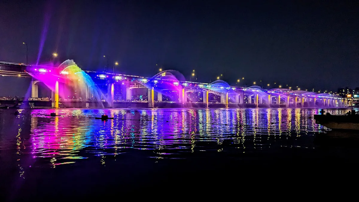 Banpo Bridge Moonlight Rainbow Fountain glowing in rainbow colors over the Han River at night